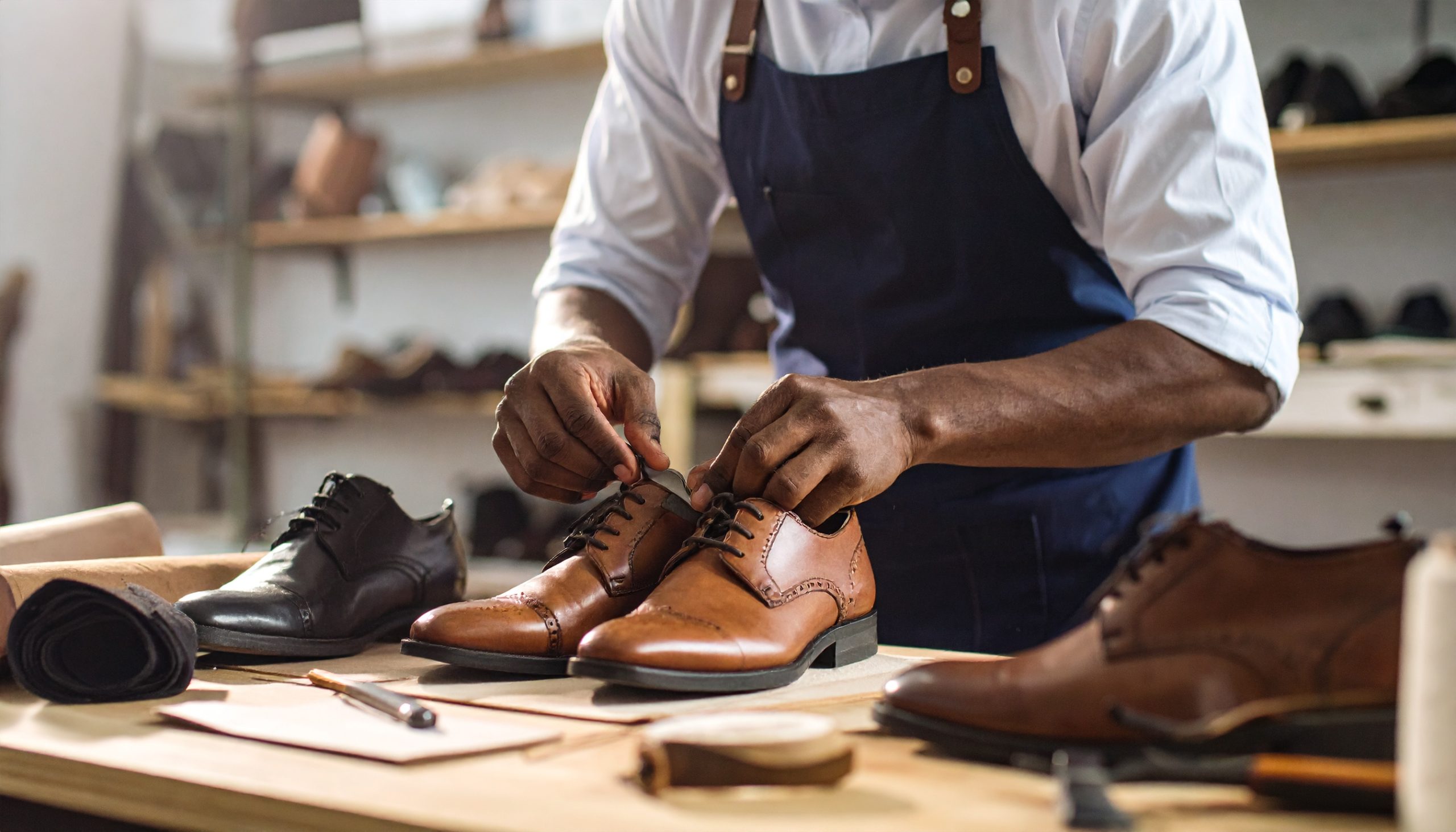 vecteezy artisan carefully lacing polished dress shoes in a 69893152